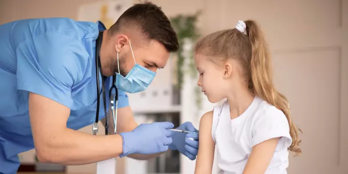 nurse administering a vaccine to