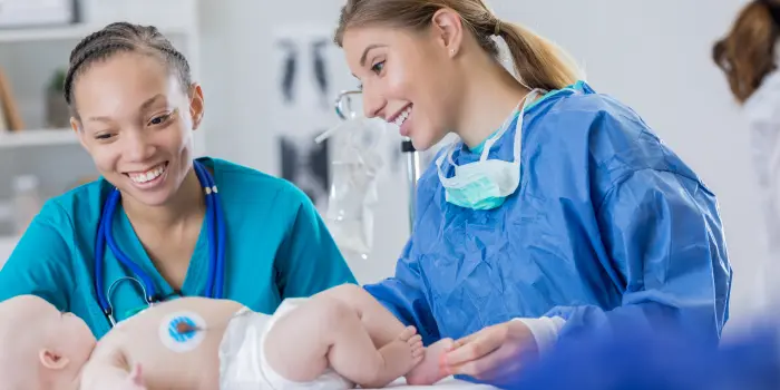 alt="Pediatric nurse examining a young patient with